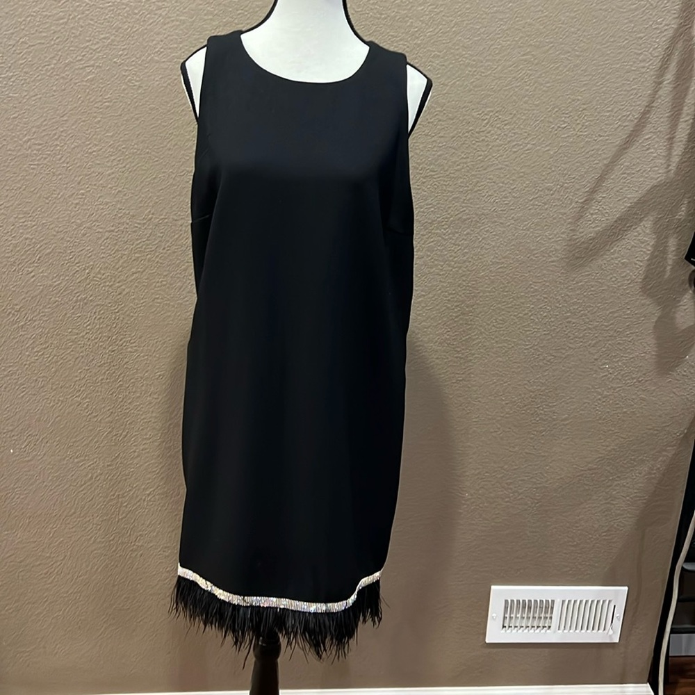 Black cocktail dress with rhinestone and feather accent